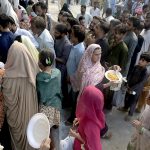 Special sweet desert Halwa is being distributed to the participants in Eid-e-Milad-un-Nabi (PBUH) rally at Jamia Masjid Road