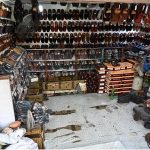 A cobbler busy in preparing the traditional shoes (Peshawari Chappal) to the customer at their workplace in the Provincial Capital