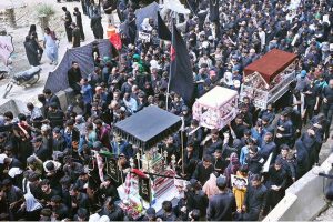 A mourning procession of the Shia community passes along M.A. Jinnah Road during the Chehlum observance commemorating the martyrdom of Hazrat Imam Hussain (AS).