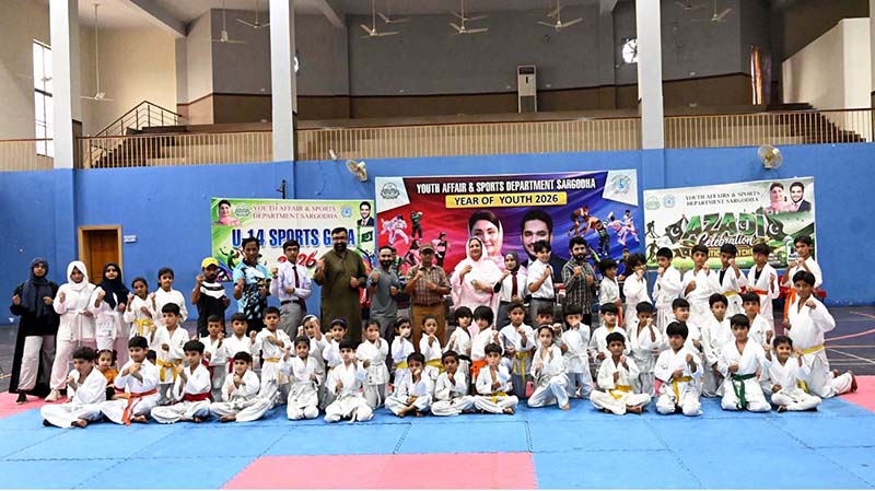 Divisional Sports Officer Rana Nadeem Anjum, District Sports Officer Saima Manzoor and Divisional Secretary Karate Association Muhammad Naeem Khan pose for a group photo with players during the Pakistan Independence Celebrations U-14 Kids Sports Gala organized by Sports department held at sports gymnasium