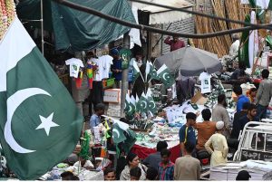 Vendors display national flags, badges and other Independence Day merchandise at Main Paper Market as the nation begins preparations to celebrate Independence Day with patriotic enthusiasm.