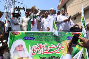 Pir Syed Sajad Shah Badshah and Pir Syed Enayat Shah along with others cutting a cake of Eid Milad-un-Nabi (SAWW)