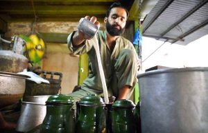 A vendor prepares traditional tea and Peshawari green tea at the historic Kehwa Khana in Qissa Khawani Bazaar, a popular gathering place known for preserving the city's rich cultural and culinary heritage.