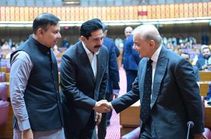 Prime Minister Muhammad Shehbaz Sharif shakes hand with parliamentarians at the session of the National Assembly.