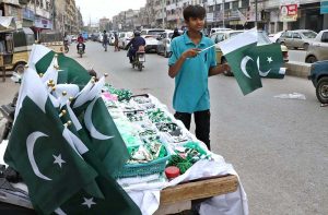 young vendors display Pakistani flags, badges and other patriotic merchandise on his stall at the Main Paper Market as preparations gain momentum for the country's Independence Day celebrations.