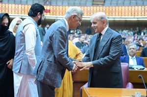 Prime Minister Muhammad Shehbaz Sharif shakes hand with parliamentarians at the session of the National Assembly.