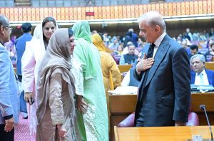 Prime Minister Muhammad Shehbaz Sharif shakes hand with parliamentarians at the session of the National Assembly.