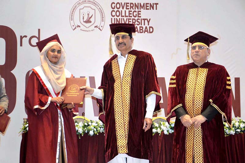 Sindh Minister for Universities and Boards Department Muhammad Ismail Rahoo awards a degree to a successful graduate during the third convocation of Government College University, Hyderabad