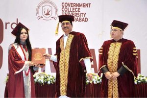 Sindh Minister for Universities and Boards Department Muhammad Ismail Rahoo awards a degree to a successful graduate during the third convocation of Government College University, Hyderabad