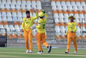 Pakistan Greens cricket fielders celebrate after dismissing a Pakistan Whites batter during the National Champions Cup 2026–27 match at Multan Cricket Stadium