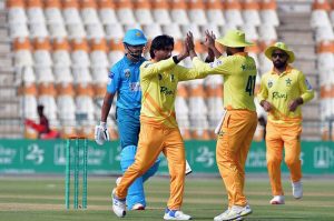 Pakistan Greens cricket fielders celebrate after dismissing a Pakistan Whites batter during the National Champions Cup 2026–27 match at Multan Cricket Stadium