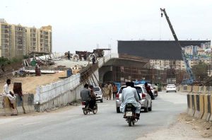 A view of the under-construction bridge at Safoora Chowrangi near the Red Line BRT project on University Road in the city.