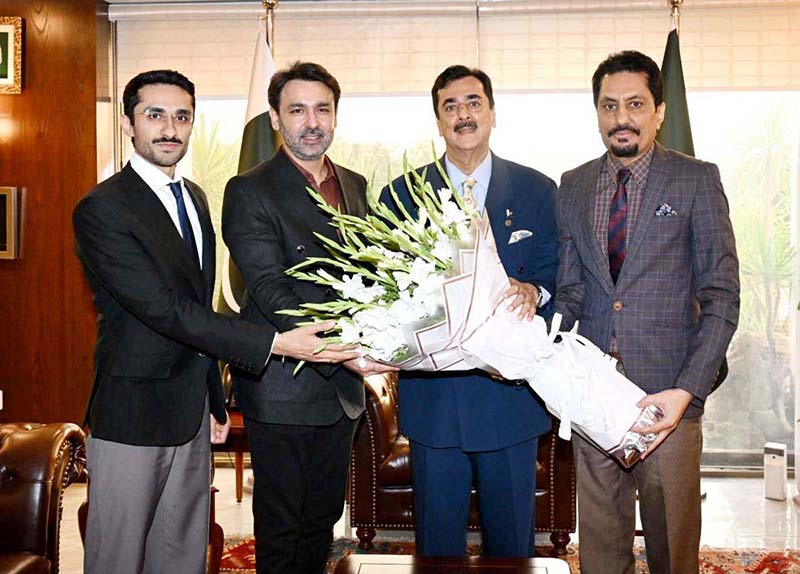 Chairman and Editor-in-Chief of Pakistan Observer Faisal Zahid Malik presents a bouquet to Chairman Senate Syed Yousuf Raza Gilani at Parliament House