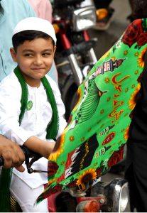 A child on a motorcycle participating in procession on the occasion of Eid Milad-un-Nabi, the birth anniversary of Holy Prophet Muhammad (PBUH)