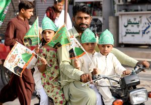 A child on a motorcycle participating in procession on the occasion of Eid Milad-un-Nabi, the birth anniversary of Holy Prophet Muhammad (PBUH)
