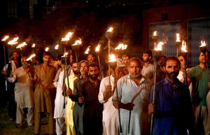 People carrying flaming torches participate in a torchlight procession (Mashal Bardar Jaloos) held on the eve of Eid Milad-un-Nabi (PBUH) to commemorate the birth anniversary of the Holy Prophet (PBUH).