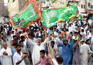 A child on a motorcycle participating in procession on the occasion of Eid Milad-un-Nabi, the birth anniversary of Holy Prophet Muhammad (PBUH)