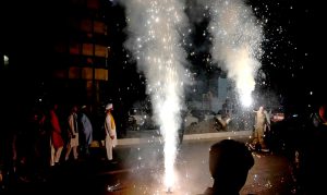 A man holds a firework in his hand during a torchlight procession (Mashal Bardar Jaloos) held on the eve of Eid Milad-un-Nabi (PBUH) to commemorate the birth anniversary of the Holy Prophet (PBUH).