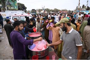 Free food are being distributing among the people participating in main procession of Eid Milad-un-Nabi, the birth anniversary of Holy Prophet Muhammad (PBUH) at M.A Jinnah Road near Numaish Chowrangi