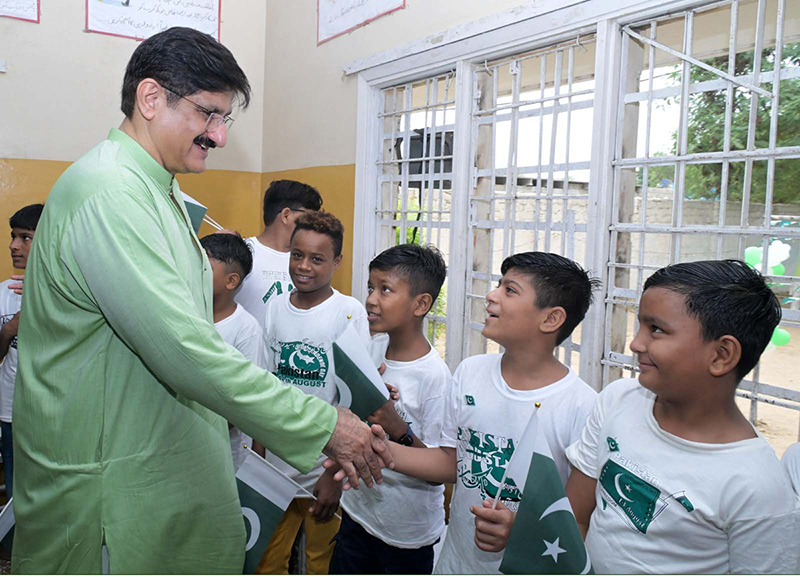 Sindh Chief Minister Syed Murad Ali Shah interacts with a child undergoing rehabilitation from drug addiction during his visit to the Aas Foundation in Haji Sukhio Goth on the occasion of Independence Day