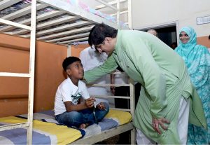 Sindh Chief Minister Syed Murad Ali Shah interacts with a child undergoing rehabilitation from drug addiction during his visit to the Aas Foundation in Haji Sukhio Goth on the occasion of Independence Day