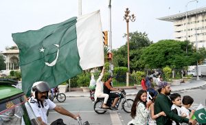 People hold national flag to celebrate the country's Independence Day
