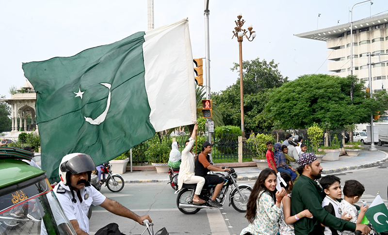 People hold national flag to celebrate the country's Independence Day