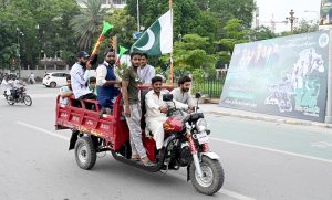 People hold national flag to celebrate the country's Independence Day