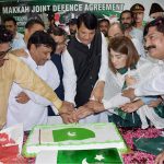 Engr Amir Muqam, Federal Minister for SAFRON, Kashmir Affairs and Gilgit-Baltistan cutting cake along with other officials on Pakistan Independence Day function at PMLN Secretariat