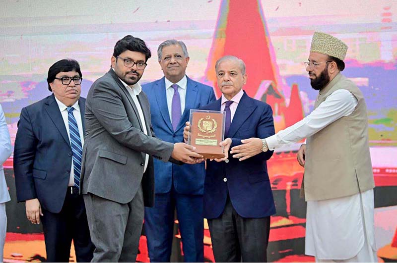 Prime Minister Muhammad Shehbaz Sharif presenting awards to the members of Religious Minorities of Pakistan who contributed towards the sustained benefits of the society