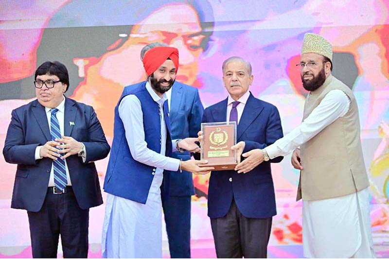 Prime Minister Muhammad Shehbaz Sharif presenting awards to the members of Religious Minorities of Pakistan who contributed towards the sustained benefits of the society