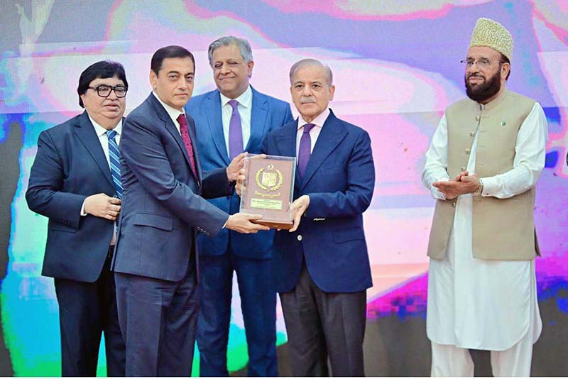 Prime Minister Muhammad Shehbaz Sharif presenting awards to the members of Religious Minorities of Pakistan who contributed towards the sustained benefits of the society
