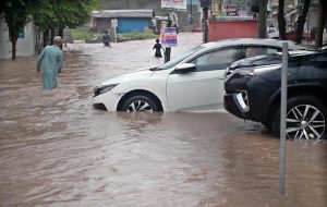 Vehicles move through stagnant rainwater in Ghouri Town following heavy monsoon rainfall in the Federal Capital.