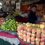 A vendor selling fruits to attract customers at weekly bazar Peshawar morr in the Federal Capital