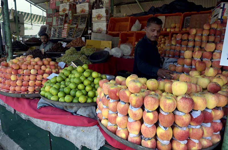 A vendor selling fruits to attract customers at weekly bazar Peshawar morr in the Federal Capital