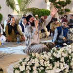 A naat khawan recites during a Mehfil-e-Milad held in Media Town, as attendees listen attentively
