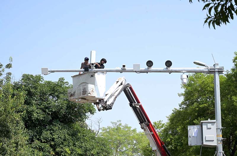 Workers carry out maintenance work on CCTV cameras installed in the Federal Capital