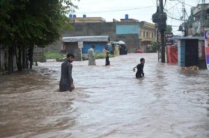 Vehicles move through stagnant rainwater in Ghouri Town following heavy monsoon rainfall in the Federal Capital.