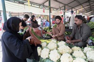 A vendor selling fruits to attract customers at weekly bazar Peshawar morr in the Federal Capital