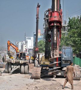Heavy machinery and construction crews are working on the rehabilitation, expansion, and dualization of the eastern service road along the Islamabad Expressway as part of a Capital Development Authority (CDA) project to upgrade the 9-kilometre stretch from Faizabad Interchange to Gulberg Greens into a six-lane carriageway.