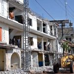 Heavy machinery is being used to demolish illegally constructed plazas built on a road for the expansion of the service road along the Islamabad Expressway