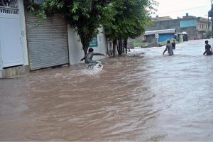 Vehicles move through stagnant rainwater in Ghouri Town following heavy monsoon rainfall in the Federal Capital.