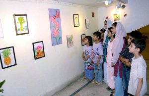 Young visitors view artworks displayed at the Kids Art & Painting Exhibition at the Punjab Council of the Arts.
