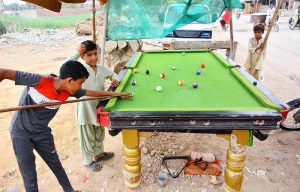 Children enjoy playing snooker at Makrani Para.