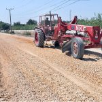 Labourers are busy leveling the ground for road construction as part of development work in Latifabad near a public school