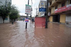 Vehicles move through stagnant rainwater in Ghouri Town following heavy monsoon rainfall in the Federal Capital.