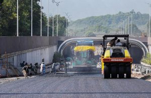 Heavy machinery and labourers work to complete the Park Road Underpass project, which is nearing completion.