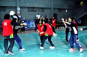 A girls player scores during a netball match between Government Girls High School and Hayat Girls High School at the 5th PNF Netball Cup 2026, held at Hyderabad Club Badminton Hall.