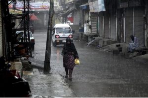 A woman gets drenched in heavy rain while heading home without any protective gear as downpour lashes the twin cities.