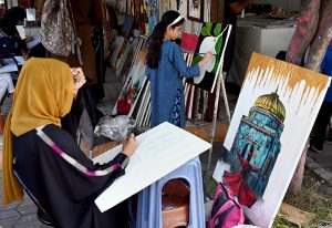 Students learn painting techniques at an art training stall H-9 weekly bazaar in the Federal Capital